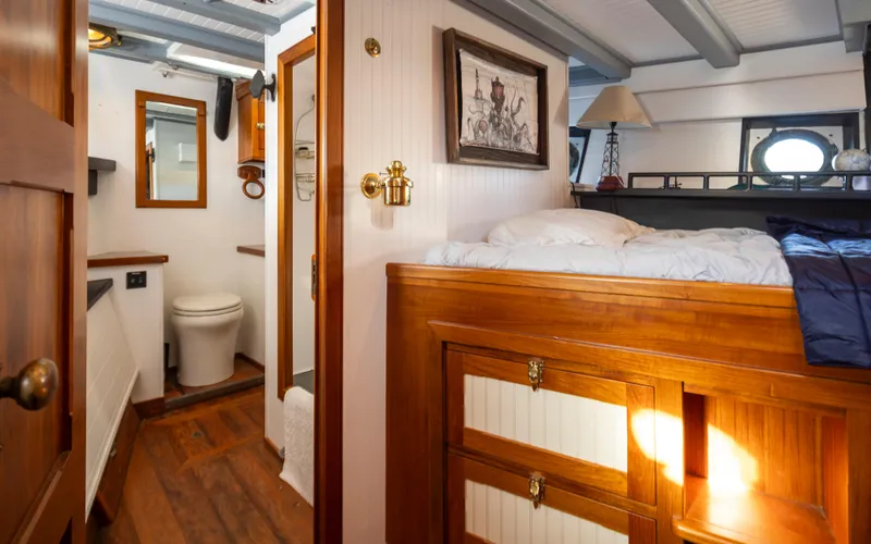 Slide: The Image of 1931 Boeing Custom interior with wooden bed, nautical decor, and compact bathroom. - 45