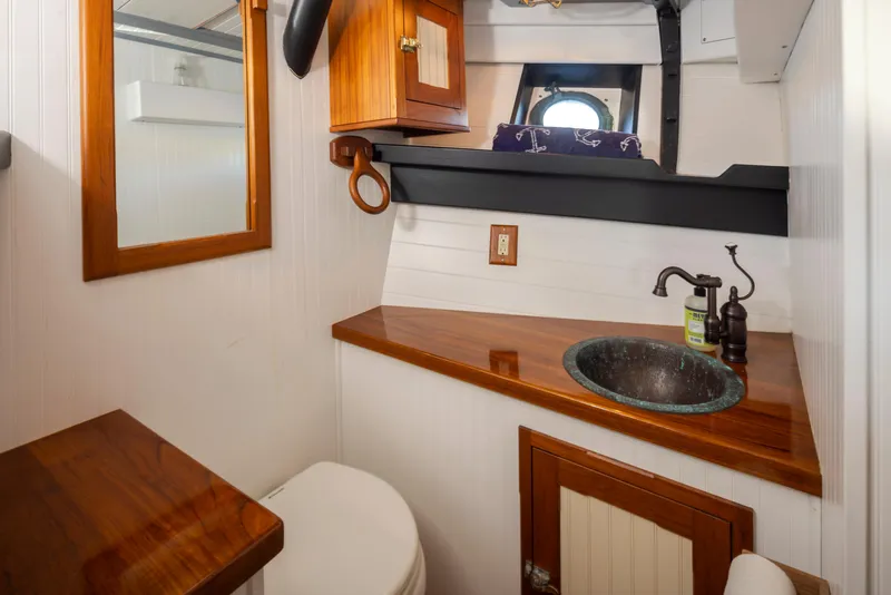 Slide: The Image of Vintage 1931 Boeing Custom boat bathroom with wooden accents and porthole window. - 47