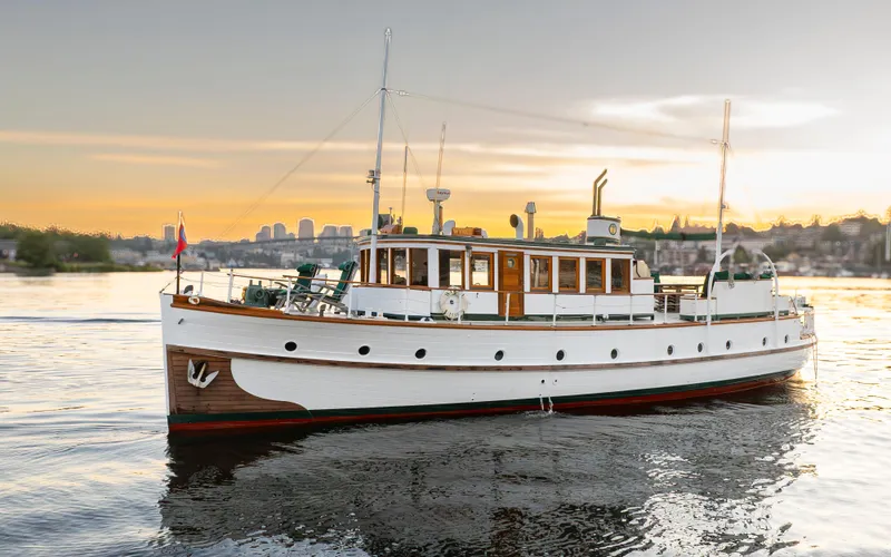 Slide: The Image of Vintage 1931 Boeing Custom yacht on serene water at sunset. - 5