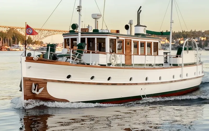 Slide: The Image of Vintage 1931 Boeing Custom boat cruising on a calm waterway, with scenic background. - 8