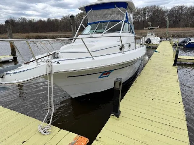 Slide: The Image of 1996 Pro-Line 2950 Mid Cabin boat docked on a wooden pier. - 10