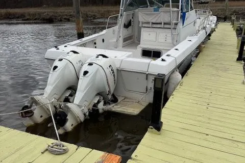 Slide: The Image of 1996 Pro-Line 2950 Mid Cabin boat docked with dual Evinrude outboard motors. - 11