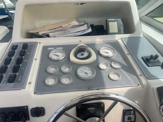 Slide: The Image of 1996 Pro-Line 2950 Mid Cabin dashboard with gauges, steering wheel, and navigation equipment. - 6