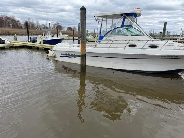 Slide: The Image of 1996 Pro-Line 2950 Mid Cabin boat docked in a marina. - 9