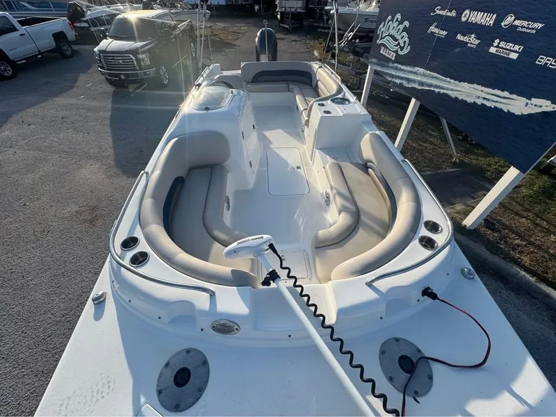 Slide: The Image of 2018 Hurricane SS 232 boat with spacious seating and modern design, displayed outdoors. - 2