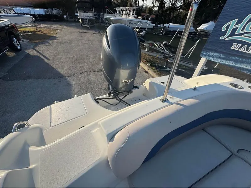 Slide: The Image of 2018 Hurricane SS 232 boat with 150 HP outboard motor, docked at marina. - 7