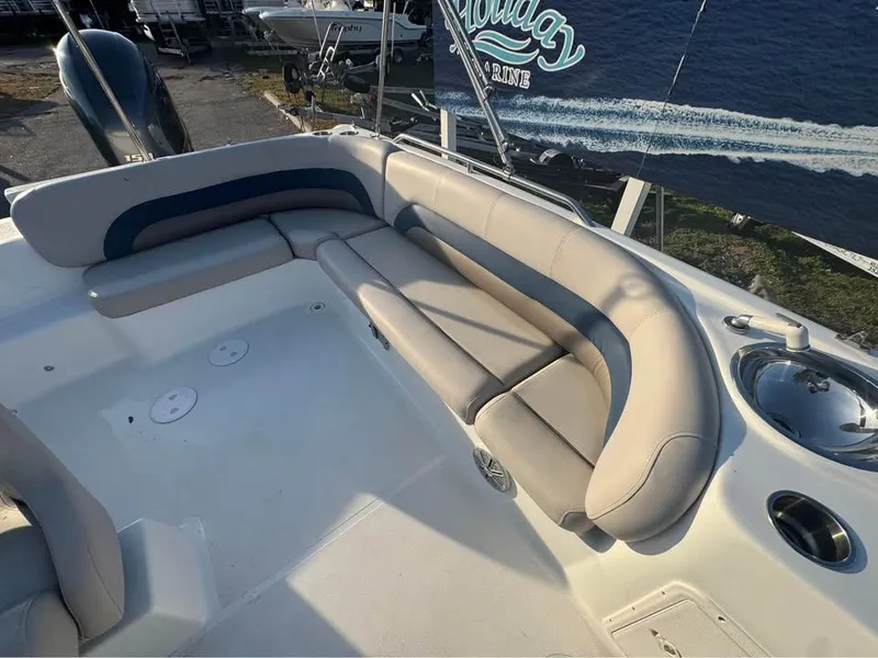 Slide: The Image of 2018 Hurricane SS 232 boat with spacious seating and cup holders, docked near water. - 8