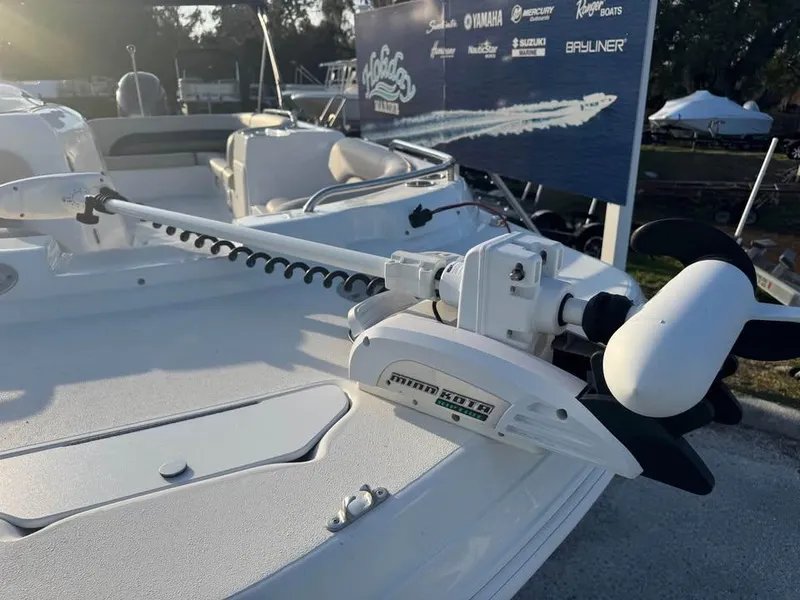 Slide: The Image of 2018 Hurricane SS 232 boat with trolling motor on deck, displayed outdoors. - 9