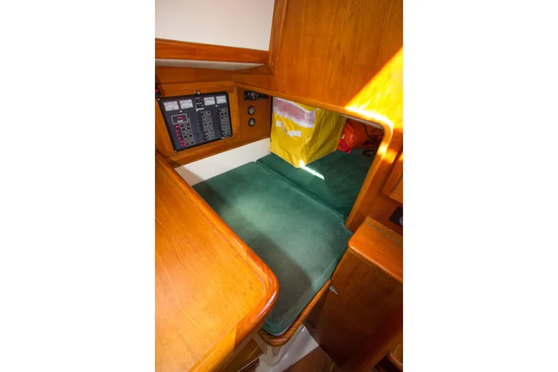 Slide: The Image of Interior cabin of 1992 Pacific Seacraft 34 sailboat with control panel and green cushion. - 19