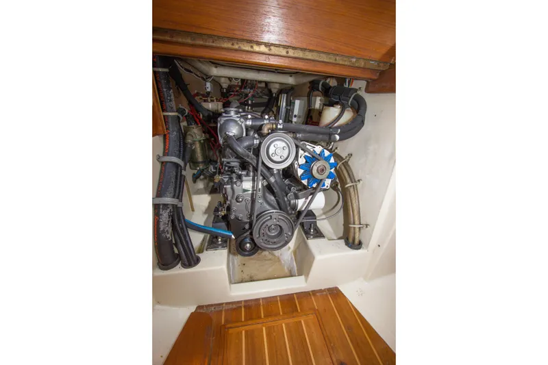Slide: The Image of Engine compartment of a 1992 Pacific Seacraft 34 sailboat, showcasing mechanical components. - 21