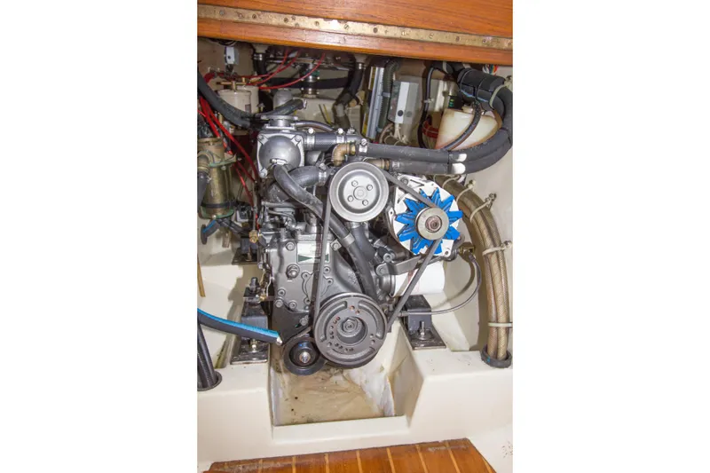 Slide: The Image of Engine compartment of a 1992 Pacific Seacraft 34 sailboat, showcasing mechanical components. - 22