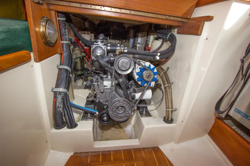 Slide: The Image of Engine compartment of a 1992 Pacific Seacraft 34 sailboat, showcasing mechanical components. - 23