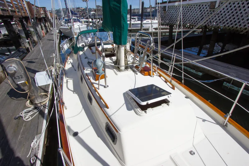 Slide: The Image of 1992 Pacific Seacraft 34 sailboat docked, showcasing deck and rigging details. - 25