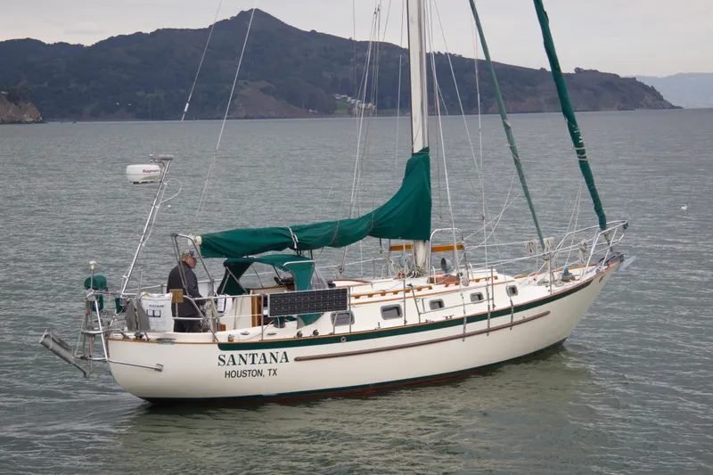Slide: The Image of Sailboat "Santana," Pacific Seacraft 34, 1992, on water near mountainous coastline. - 4