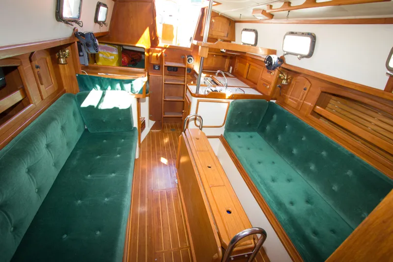 Slide: The Image of Interior of 1992 Pacific Seacraft 34 sailboat with green upholstery and wooden finishes. - 9