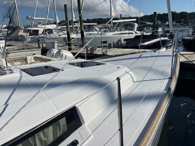 Slide: The Image of 2017 Beneteau Oceanis 38.1 sailboat docked at marina, showcasing sleek deck design. - 12