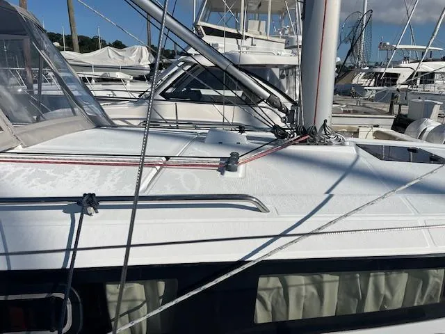 Slide: The Image of 2017 Beneteau Oceanis 38.1 sailboat deck with rigging in a marina. - 13