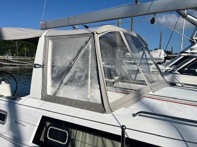 Slide: The Image of 2017 Beneteau Oceanis 38.1 sailboat with cockpit enclosure, docked in marina. - 14