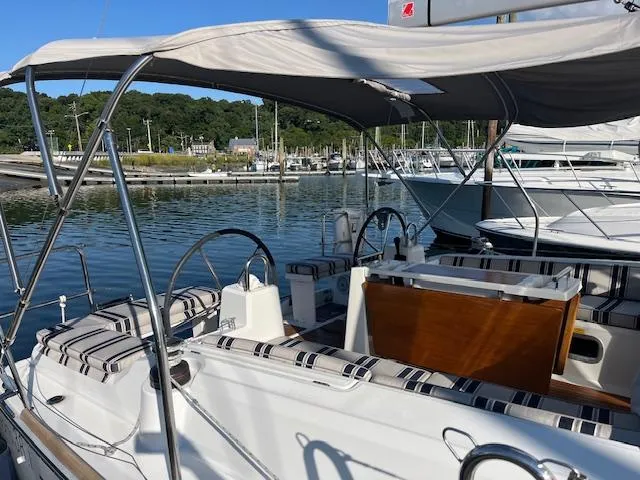 Slide: The Image of Beneteau Oceanis 38.1 sailboat, 2017 model, docked in a marina with striped seating. - 15