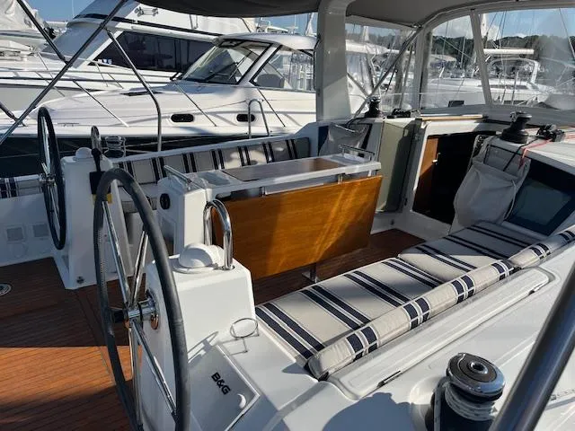 Slide: The Image of 2017 Beneteau Oceanis 38.1 yacht cockpit with dual steering wheels and striped seating. - 17