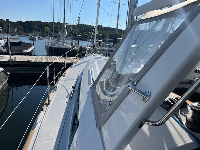 Slide: The Image of 2017 Beneteau Oceanis 38.1 sailboat docked at a marina, side deck view. - 22