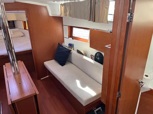 Slide: The Image of 2017 Beneteau Oceanis 38.1 interior with cozy seating and wooden finishes. - 27