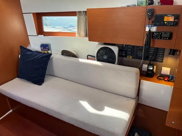 Slide: The Image of Interior of 2017 Beneteau Oceanis 38.1 yacht with beige sofa and navigation equipment. - 29