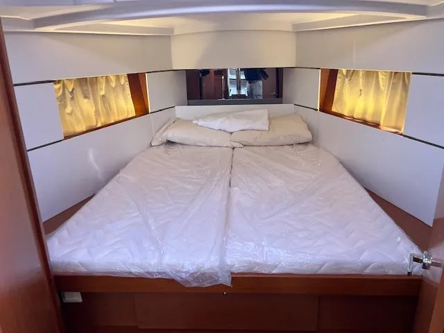 Slide: The Image of Cozy cabin interior of 2017 Beneteau Oceanis 38.1 with comfortable bedding and soft lighting. - 31