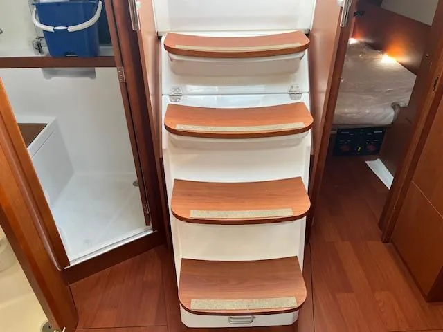 Slide: The Image of Interior of 2017 Beneteau Oceanis 38.1 yacht, featuring wooden steps and cabin access. - 39