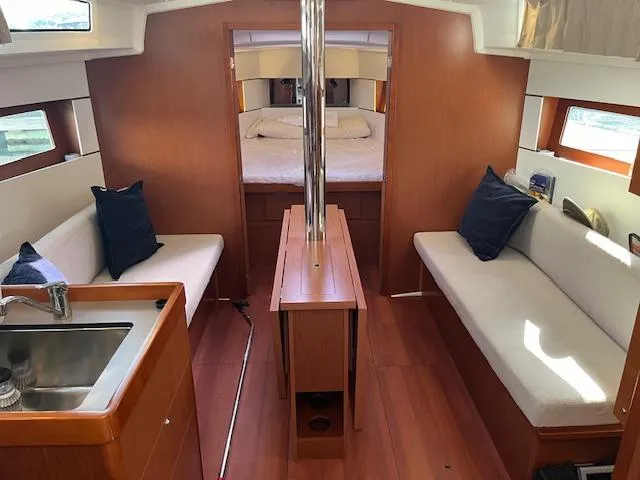 Slide: The Image of Interior of 2017 Beneteau Oceanis 38.1 sailboat with cozy seating and wood finish. - 4