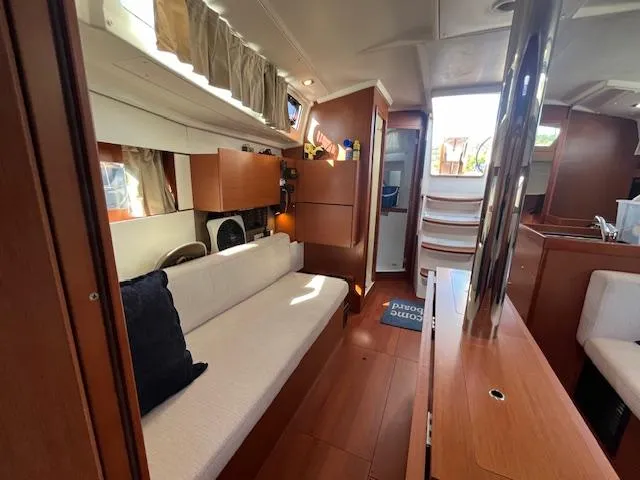 Slide: The Image of Interior of 2017 Beneteau Oceanis 38.1 yacht with modern wood finish and cozy seating. - 43