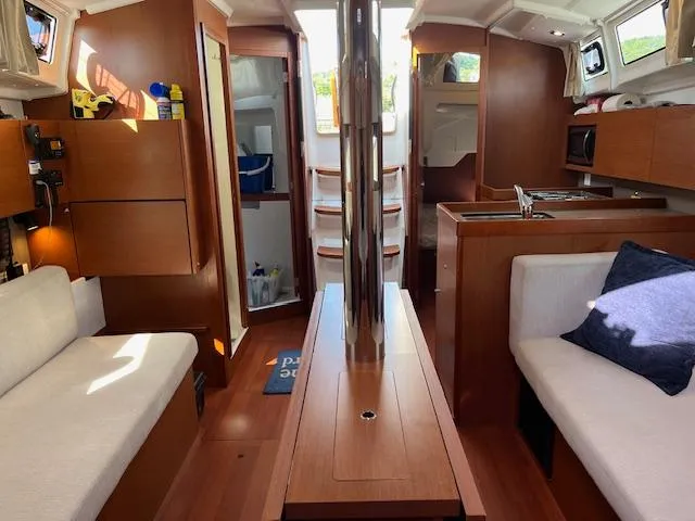 Slide: The Image of Interior of 2017 Beneteau Oceanis 38.1 sailboat with wood finish and cozy seating. - 45