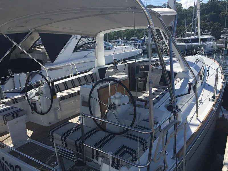 Slide: The Image of 2017 Beneteau Oceanis 38.1 sailboat with dual steering wheels docked at marina. - 48