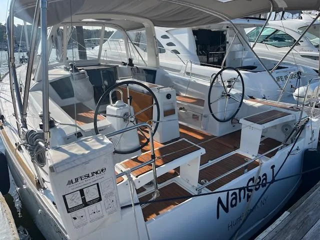 Slide: The Image of 2017 Beneteau Oceanis 38.1 sailboat with dual steering wheels and teak deck in marina. - 5