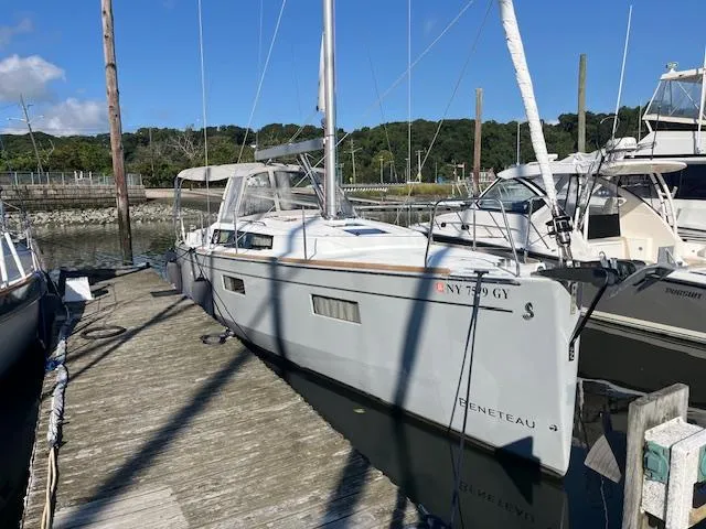 Slide: The Image of 2017 Beneteau Oceanis 38.1 sailboat docked at a marina under clear skies. - 6