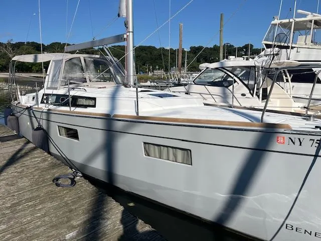Slide: The Image of 2017 Beneteau Oceanis 38.1 sailboat docked at a marina, side view. - 9