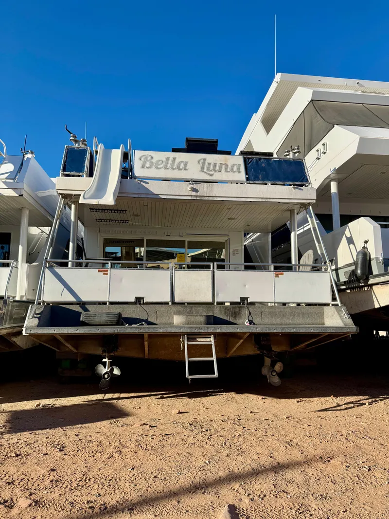 Slide: The Image of 2013 Bravada Bella Luna Trip #16 houseboat on dry land under clear blue sky. - 30