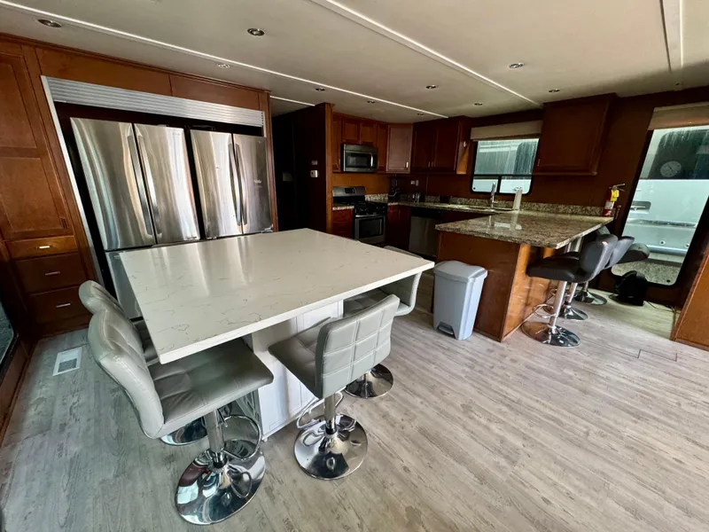 Slide: The Image of Modern kitchen interior in 2013 Bravada Bella Luna Trip #16 houseboat, featuring sleek appliances and seating. - 7