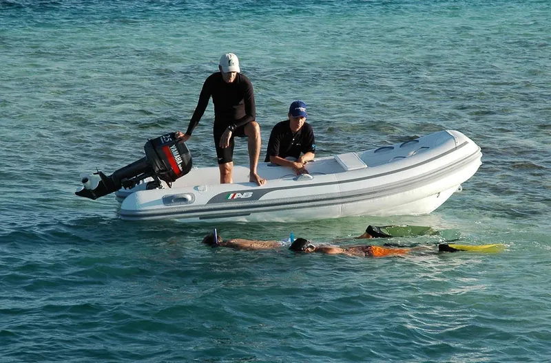 Slide: The Image of 2024 AB Inflatables Lammina 11 AL with snorkelers in clear water. - 4