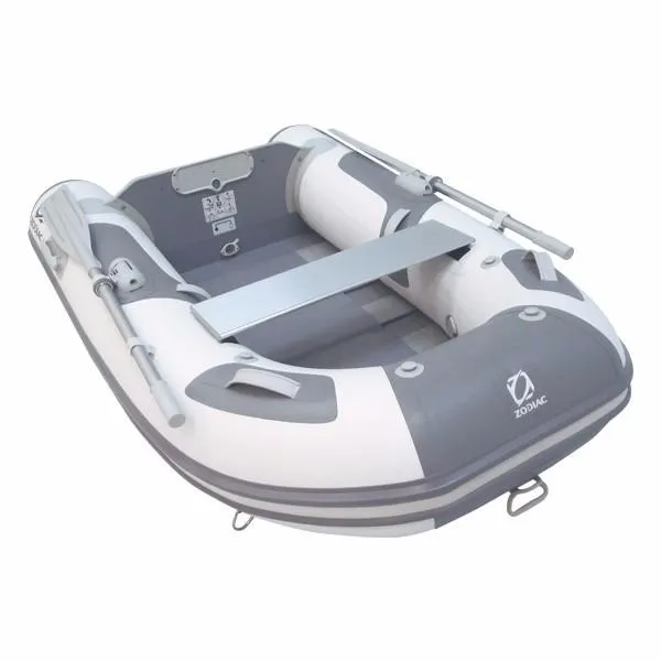 The Image of 2023 Zodiac Cadet 200 Roll-Up inflatable boat, white and gray, with oars and bench seat. - 1