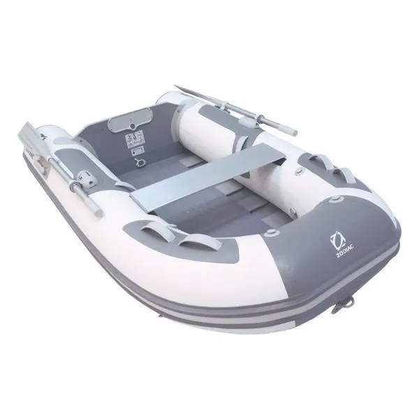 The Image of 2024 Zodiac Cadet 230 Roll-Up inflatable boat, white and gray, with oars and bench seat. - 1