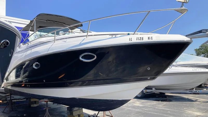 Slide: The Image of 2007 Rinker 280 Express Cruiser boat on display in a marina. - 1