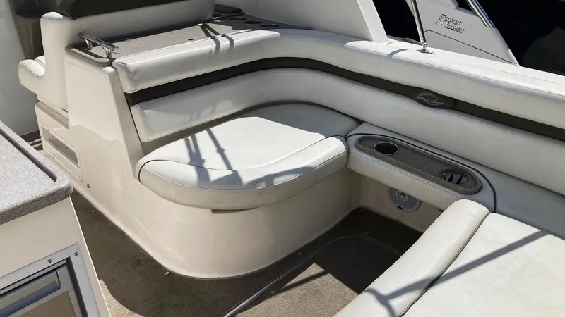 Slide: The Image of 2007 Rinker 280 Express Cruiser interior seating with cup holders and cushioned seats. - 13