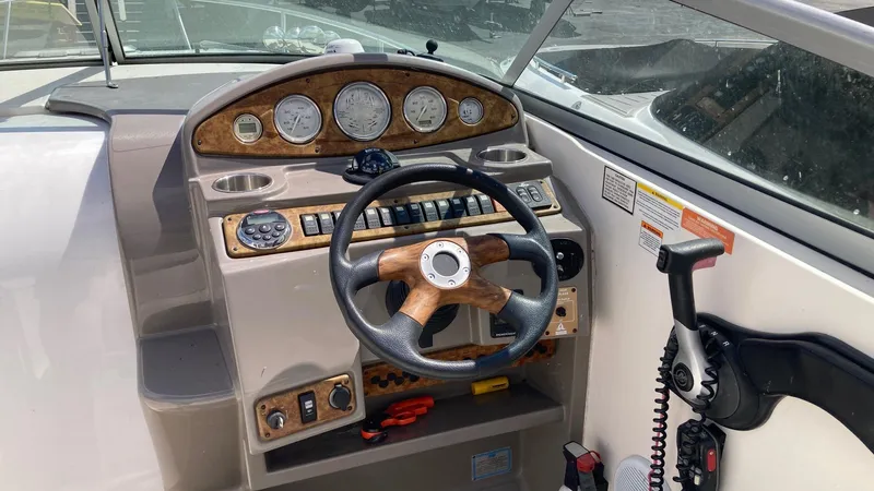 Slide: The Image of 2007 Rinker 280 Express Cruiser dashboard with steering wheel and control panel. - 15