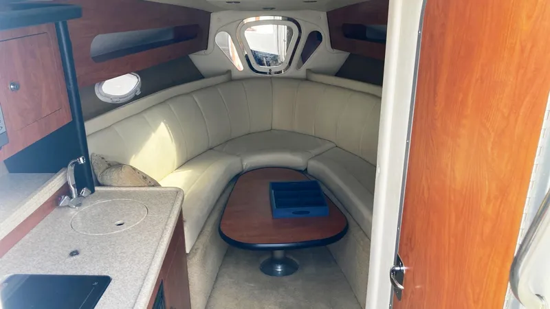 Slide: The Image of Interior of 2007 Rinker 280 Express Cruiser with cozy seating and kitchenette. - 16