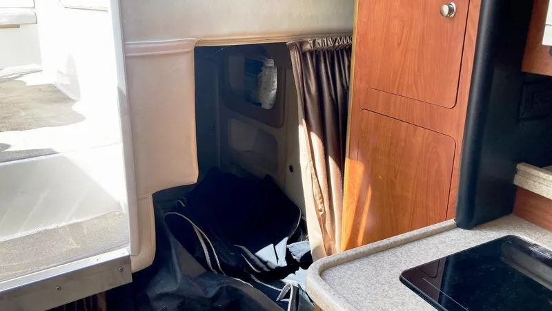 Slide: The Image of Interior of 2007 Rinker 280 Express Cruiser with kitchenette and storage area. - 20