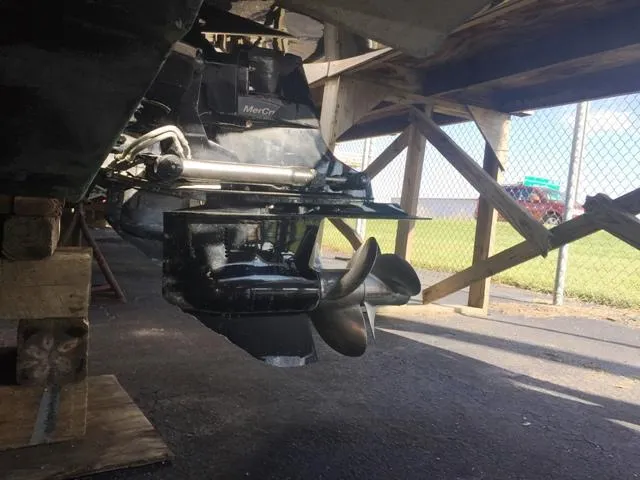 Slide: The Image of 2007 Rinker 280 Express Cruiser outdrive and propeller in dry dock. - 8