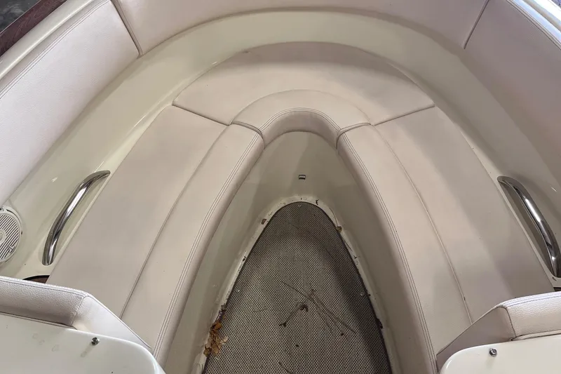 Slide: The Image of 2018 Chris-Craft 27 Launch boat interior with beige seating and stainless steel handles. - 4