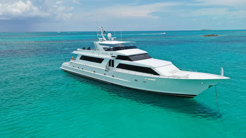 The Image of Luxurious 1991 Broward Motor Yacht cruising in clear turquoise waters. - 0