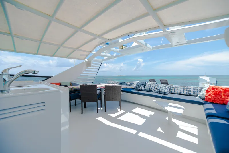 Slide: The Image of Spacious deck of 1991 Broward Motor Yacht with ocean view and seating area. - 11